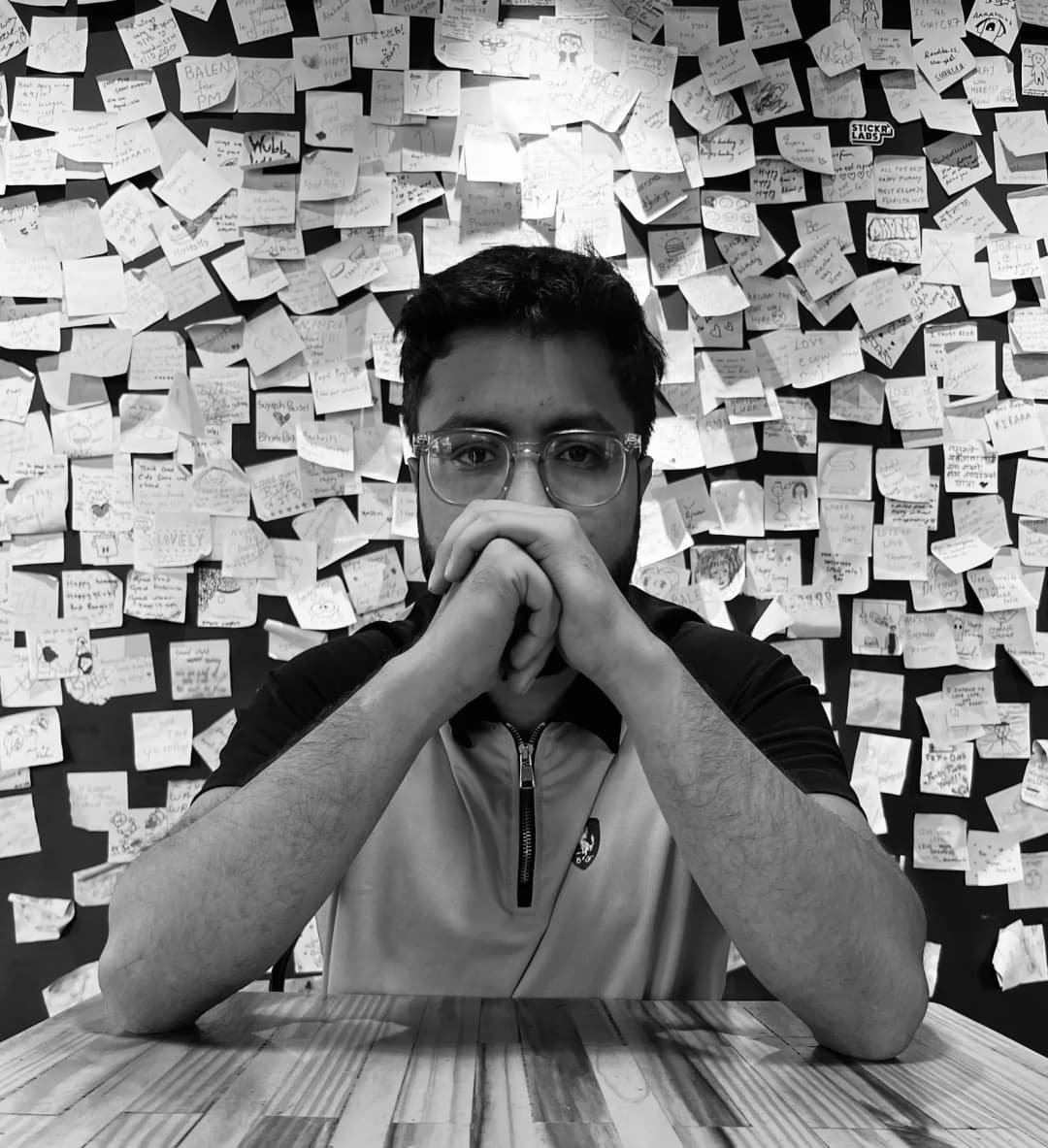 Janak Pokharel in front of a wall of handwritten notes